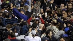 Boston Red Sox players hold up the championship trophy after Game 6 of baseball's World Series against the St. Louis Cardinals Wednesday, October 30, in Boston.