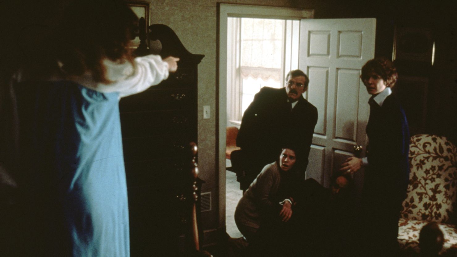 Chris MacNeil (actress Ellen Burstyn, right) looks on in horror as her daughter is controlled by the demon.