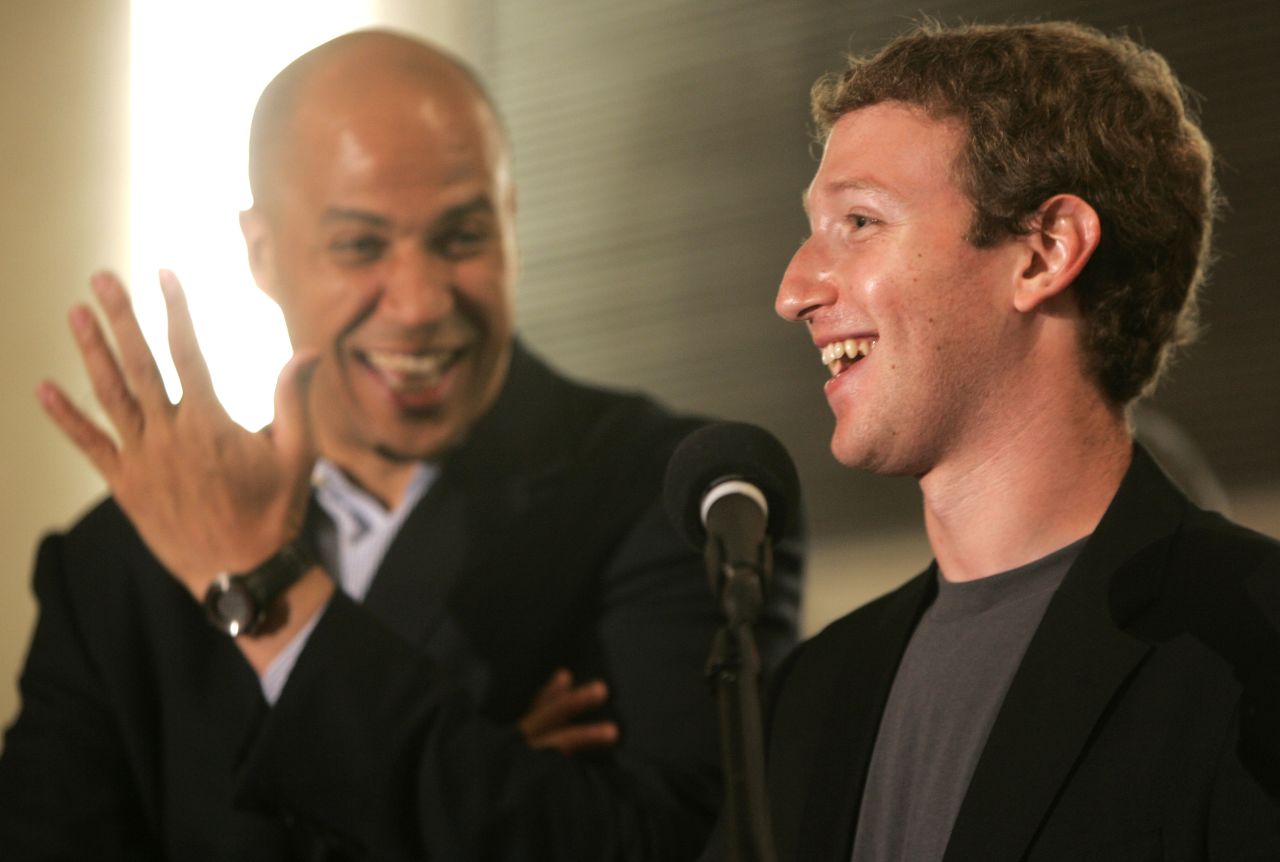 Booker laughs as Mark Zuckerberg, founder and CEO of Facebook, talks about his donation of $100 million to help Newark public schools during a news conference in September 2010.