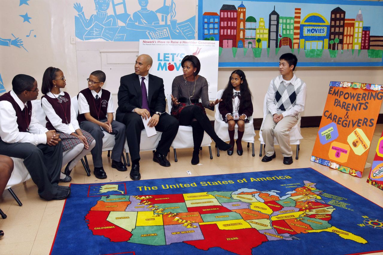 Booker and first lady Michelle Obama sit with children at the Maple Avenue School in Newark in November 2010.