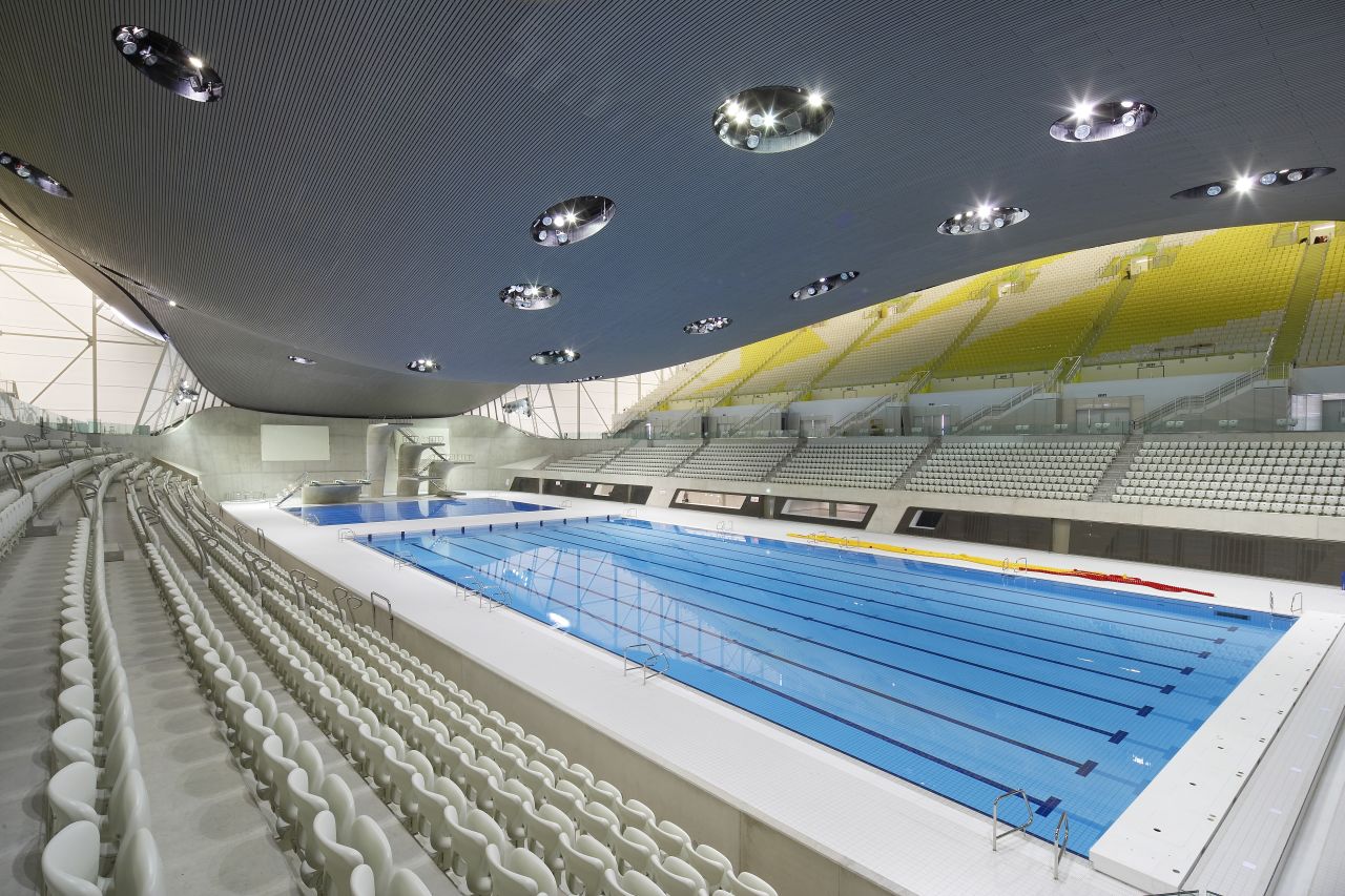 Hadid's Aquatic Centre, built for the London 2012 Olympic Games, featured a distinctive sweeping ceiling. "An undulating roof sweeps up from the ground as a wave, enclosing the pools of the Centre with its unifying gesture," she says on her website.