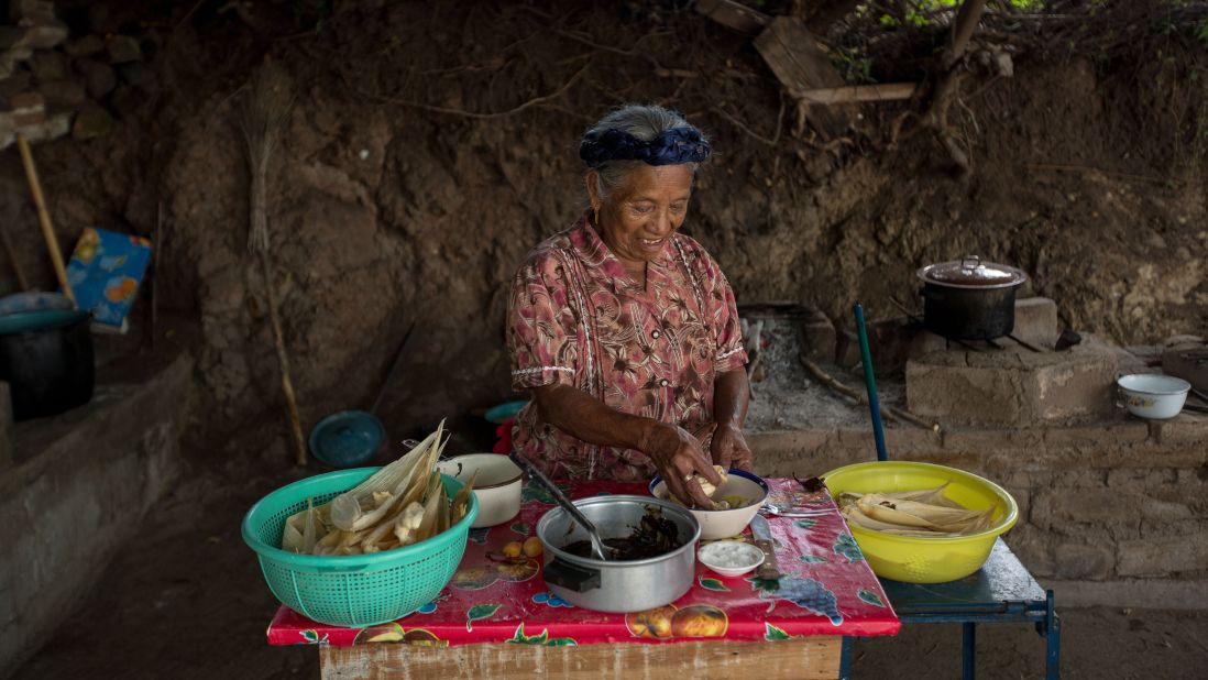 An elderly woman hand makes traditional tamales for the Day of the Dead festival. "This is one of my favorite aspects of Dia de los Muertos because my father, who recently passed away, wasn't too keen on skulls. Making tamales, bread and other favorite foods that their loved ones would have enjoyed is an important aspect of this celebration," says Cano-Murillo, "Eventually, we are all going to take our turn so wouldn't it be nice if your family and friends took a day out to remember you."