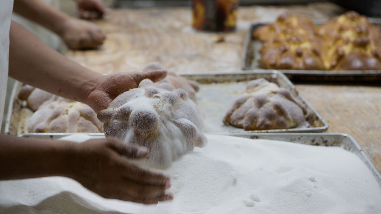 A baker adds sugar to loaves of pan de muerto at La Ideal bakery in Mexico City on Thursday, October 24. The pan de muerto, or bread of the dead, is a sweet soft bread shaped like a bun often decorated with bone-like pieces traditionally baked in Mexico during the weeks leading up to Dia de los Muertos.