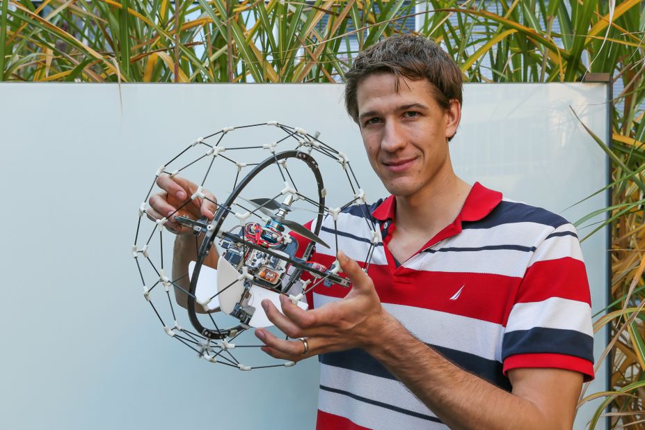 The futuristic, floating ball features a protective frame, allowing it to bounce off surfaces without damaging its in-built camera -- pictured here with co-creator Adrien Briod of the Swiss Federal Institute of Technology. 