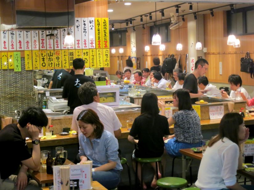 In the Taito Ward of Tokyo, excellent izakayas are well-represented, places where a hardworking salary man can have a beer or some sake or many beers and many sakes, according to Bourdain.