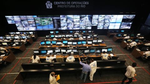 Workers gather in the Rio de Janeiro Operations Center which gathers data from 30 city agencies. According to deputy sports minister, Luis Fernandes, projects such as these will vastly improve the efficiency of cities like Rio.