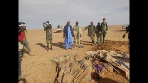 Volunteers dig graves for a group of migrants who died of thirst after their truck broke down in the Sahara Desert north of Arlit, Niger, on Wednesday, October 30. 
