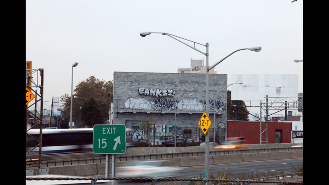 A set of balloons that reads "BANKSY!" is seen off the Long Island Expressway in Queens, New York, in October 2013. Banksy artwork appeared all over New York that month.