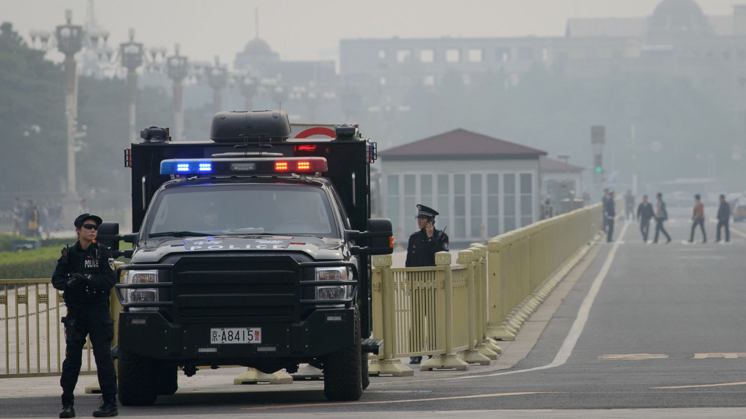 Armed police stand guard at Tiananamen Square in Beijing on Thursday.