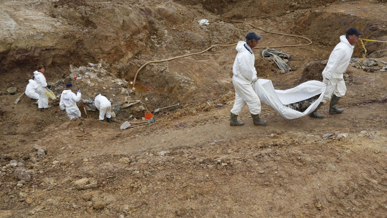 Forensic experts, members of the International Commission on Missing Persons (ICMP), and Bosnian workers search for human remains at a mass grave in the village of Tomasica, near the Bosnian town of Prijedor, 260 kms north west of Sarajevo, on Thursday, Oct. 31, 2013. Forensic experts have unearthed the 360 body  remains so far , but believe there are many more yet undiscovered as they excavate a 7 meters deep trench to find the remains of Bosniaks and Croats killed by Serb forces during their campaign to eliminate all non-Serbs from parts of the country they controlled during the 1992-95 Bosnian war. Authorities are still searching for 1,200 Bosniaks and Croats missing from the area of Prijedor. (AP Photo/Amel Emric)