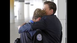 Transportation Security Administration employees hug outside Terminal 1 at Los Angeles International Airport on Friday, Nov. 1, 2013. A gunman armed with a semi-automatic rifle opened fire at Los Angeles International Airport on Friday, killing a Transportation Security Administration employee and wounding two other people. Flights were disrupted nationwide. (AP Photo/Reed Saxon)