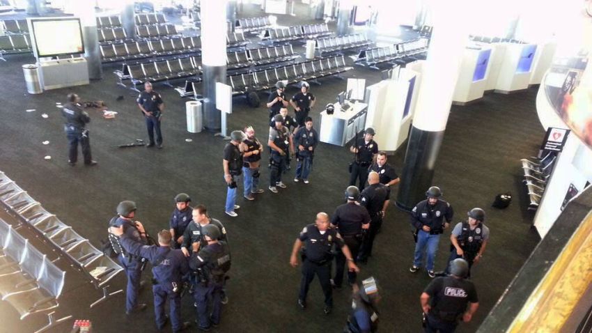Law enforcement gather in Terminal 3 near the scene of the shooting