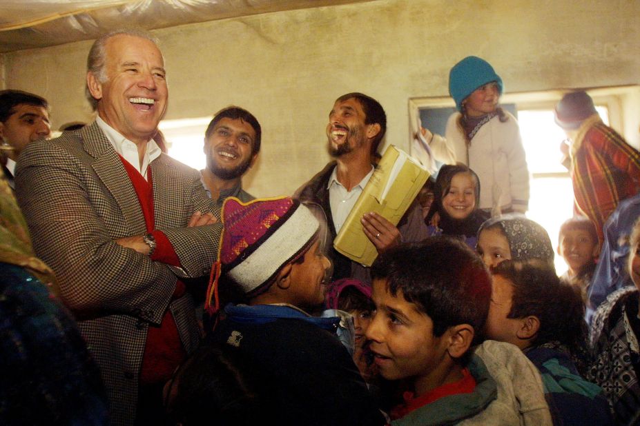 Biden, as chairman of the Senate Foreign Relations Committee, laughs with students as he visits a high school in Kabul, Afghanistan, in 2002.