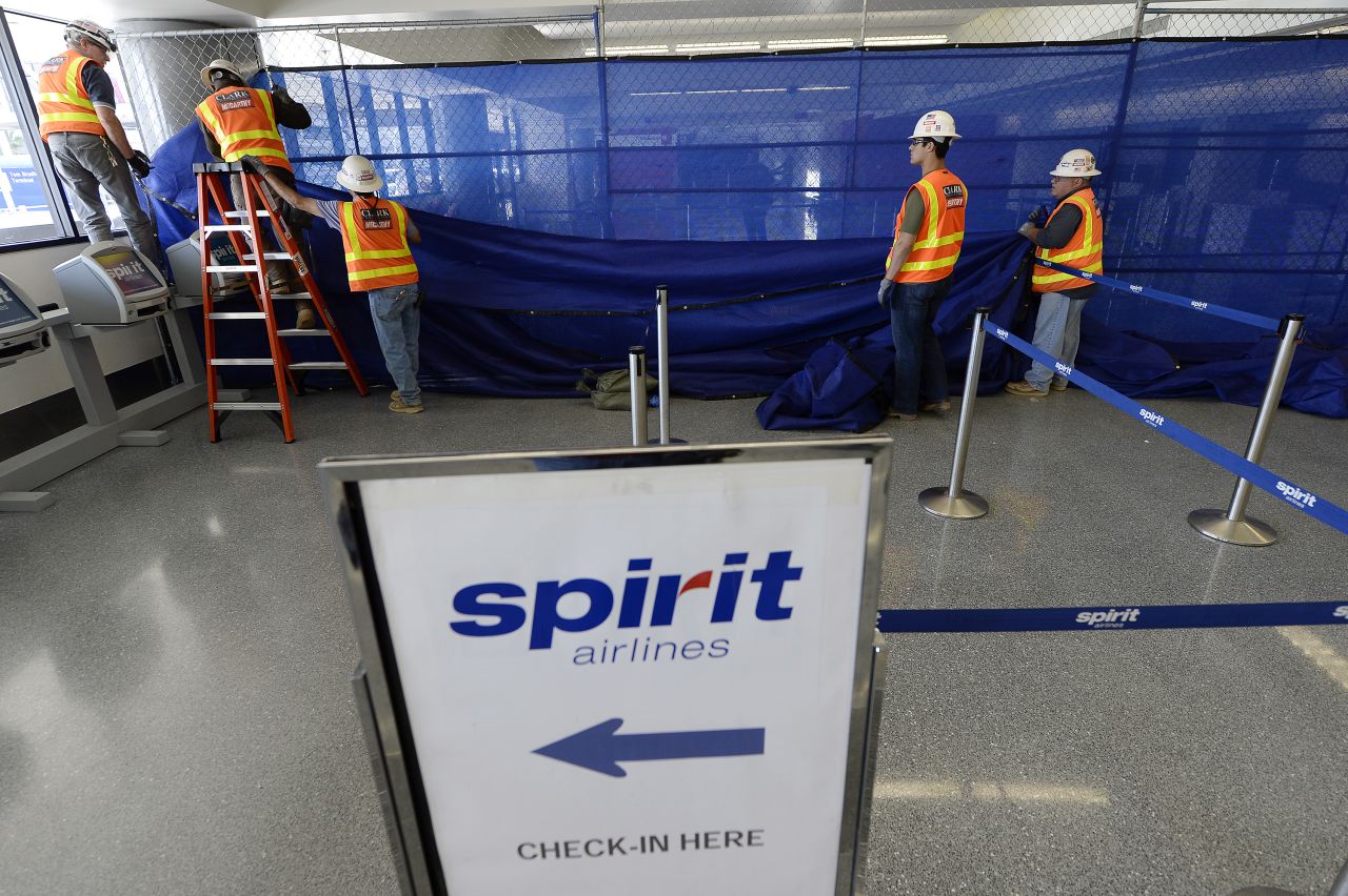 Workers tear down a temporary partition after Terminal 3 was reopened on November 2, a day after a shooting at LAX.
