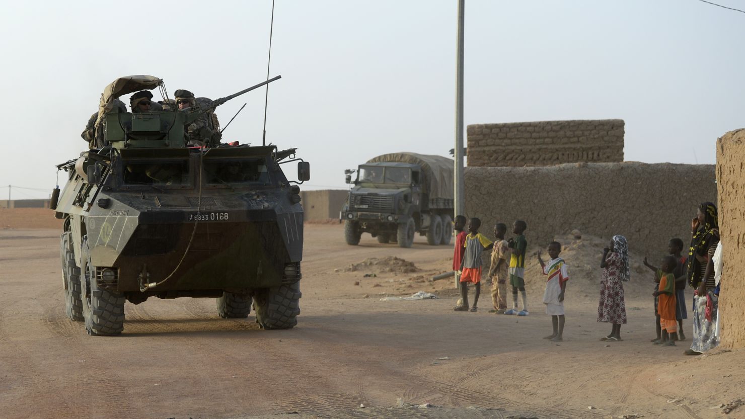 French troops have gone after militants in Mali, a former French colony. Here, a convoy passes civilians in northern Mali.