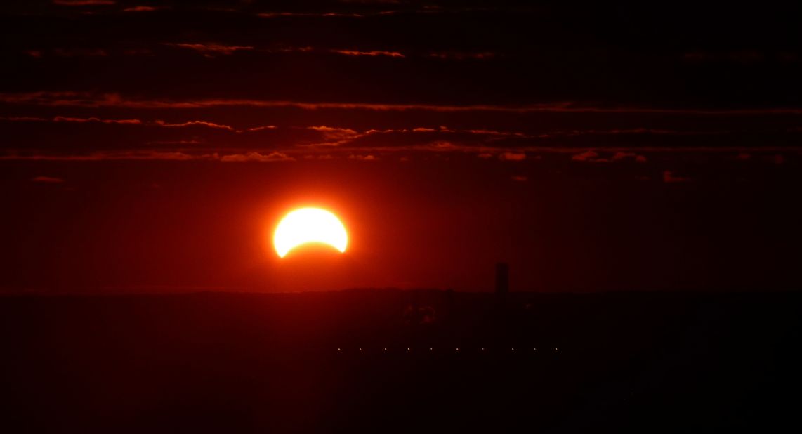 <a href="http://ireport.cnn.com/docs/DOC-1056088">Jeff Raybould </a>took advantage of his apartment view early in the morning and photographed the eclipse. "I've never seen a solar eclipse. ... I'd love to observe a total eclipse at some point," he said.