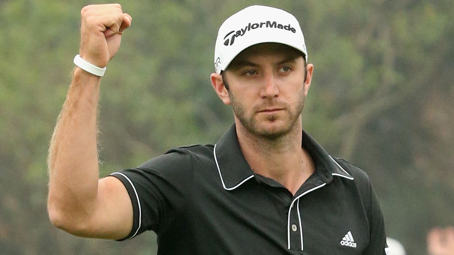 American golfer Dustin Johnson celebrates his crucial chip-in eagle on the 16th hole at the Sheshan International Golf Club.
