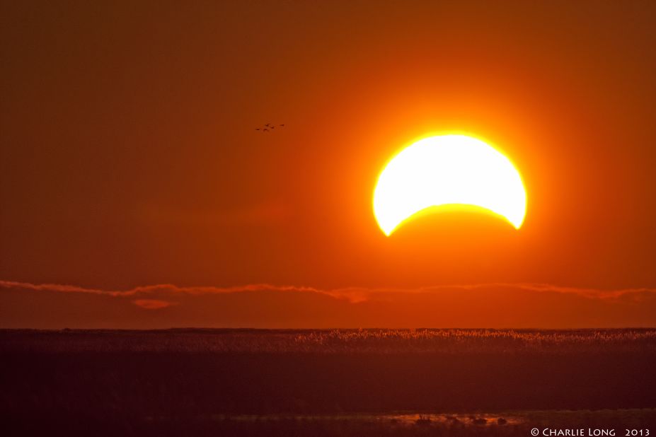 While photographing migrating waterfowl at Delaware's Bombay Hook National Wildlife Refuge, <a href="http://ireport.cnn.com/docs/DOC-1056317">Charlie Long</a> captured the eclipse early Sunday morning.