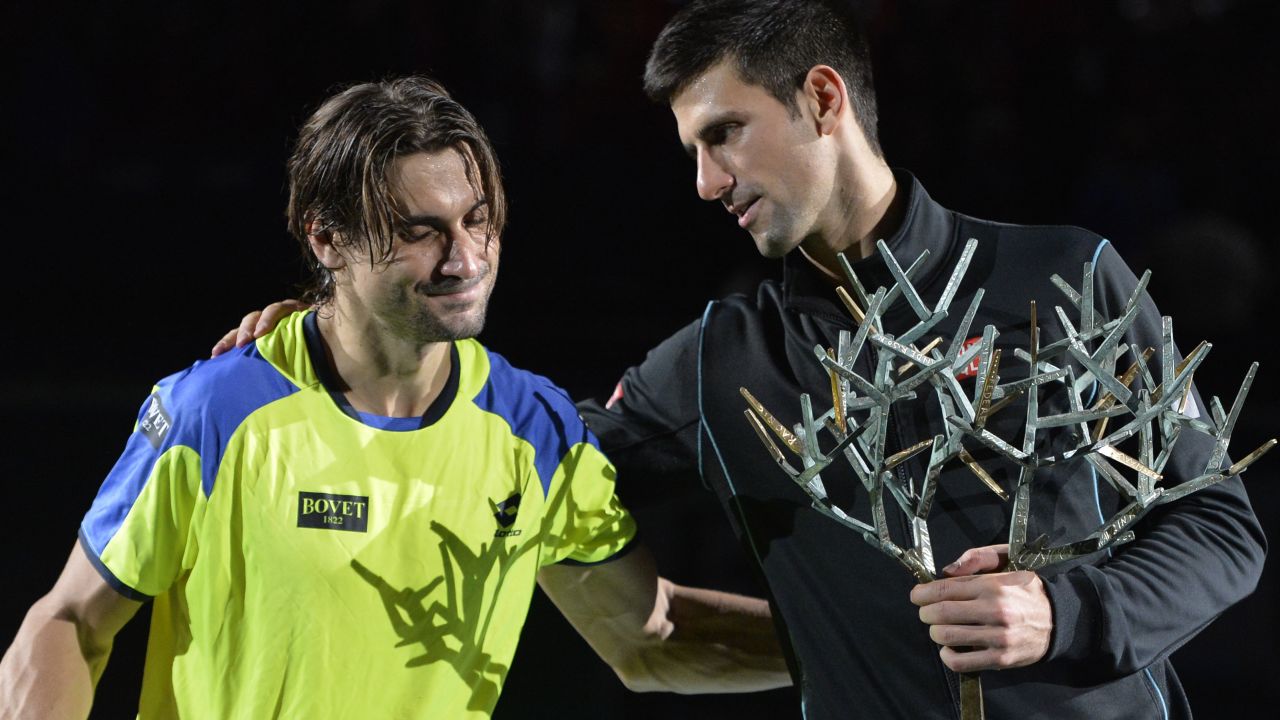 Serbia's winner Novak Djokovic (R) and Spain's David Ferrer pose with their trophies after the final match of the ninth and final ATP World Tour Masters 1000 indoor tennis tournament on November 3, 2013 at the Bercy Palais-Omnisport (POPB) in Paris. AFP PHOTO / MIGUEL MEDINA (Photo credit should read MIGUEL MEDINA/AFP/Getty Images