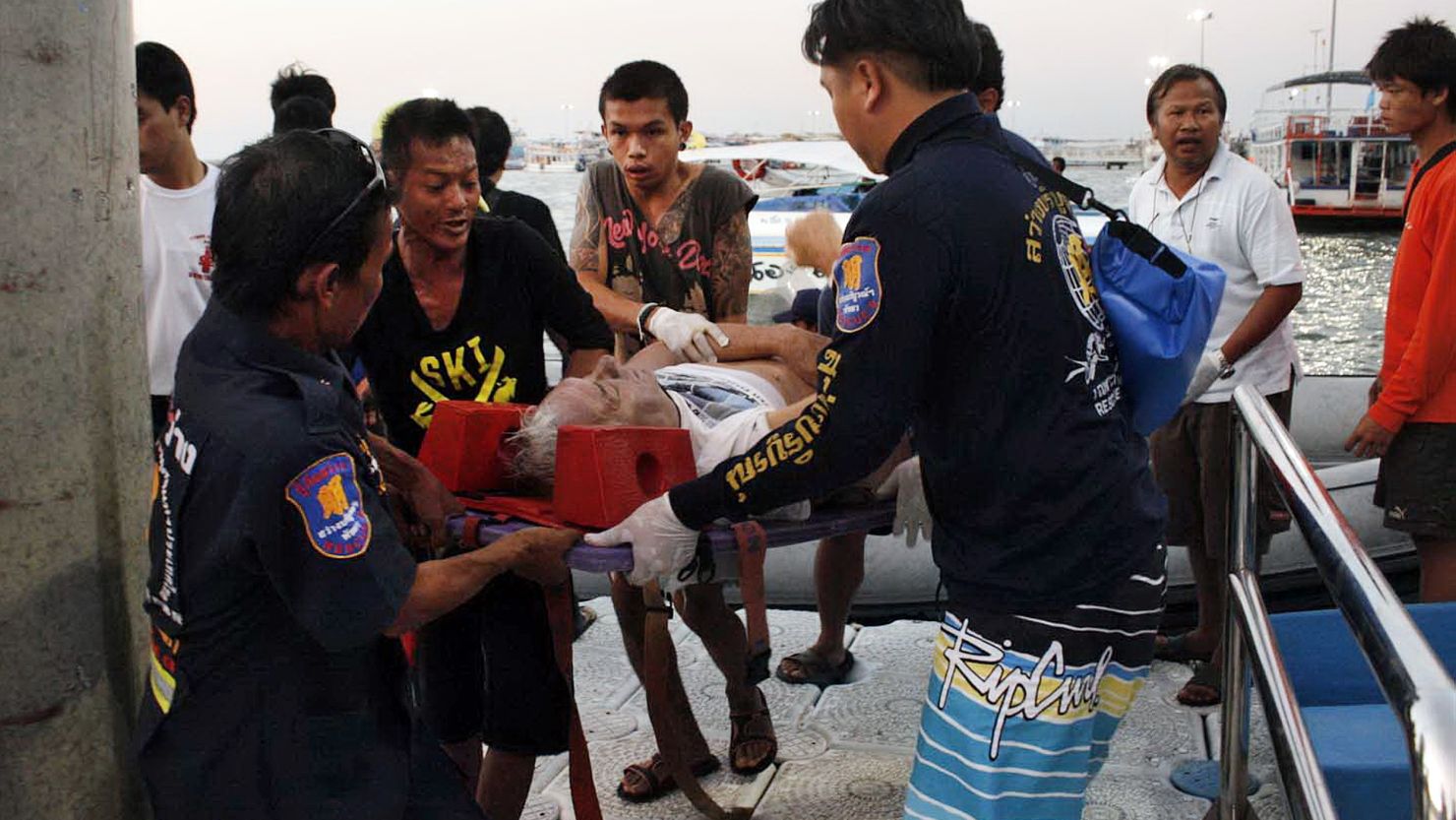 Thai rescue personnel evacuate an injured foreign tourist after a ferry sank off the coast in Pattaya on November 3, 2013.