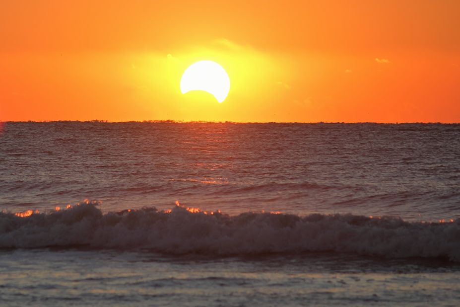 <a href="http://ireport.cnn.com/docs/DOC-1056278">Cindy Branscome </a>stood at the edge of the ocean on the Isle of Palms, South Carolina, to photograph the eclipse. She said she vaguely remembers seeing an eclipse several years ago, but this time was more special because she loves photography now.