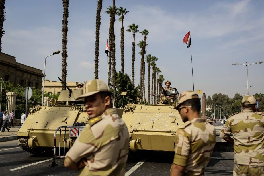 Egyptian military soldiers stand guard in Cairo the day before the trial began.