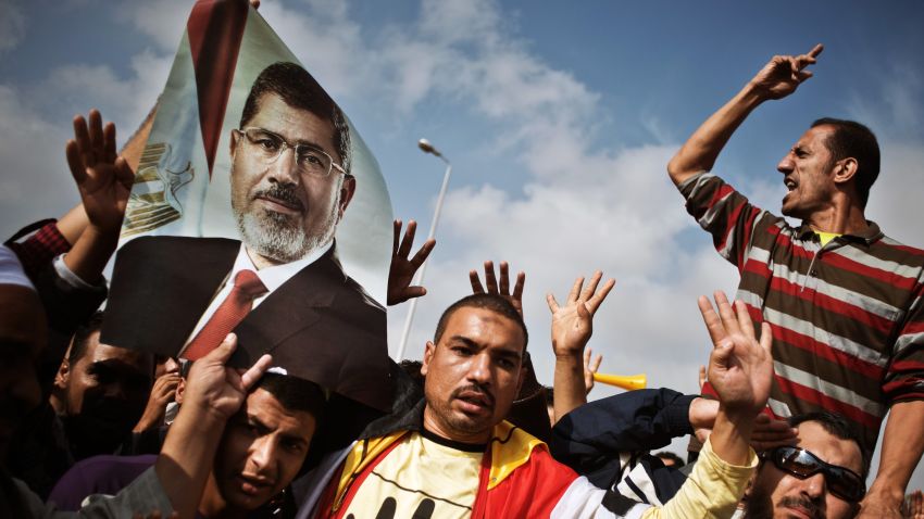 Egyptian supporters of the Muslim Brotherhood or ousted president Mohammed Morsi shout slogans in his support during a protest outside the Police Academy where Morsi's trial takes place on November 4, 2013 in Cairo, Egypt.