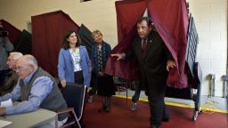 New Jersey Gov. Chris Christie exits a voting booth after casting his ballot for New Jersey governor in the general election as his wife Mary Pat Christie (L) looks on in a polling center on November 05, 2013 in Mendham, New Jersey. 