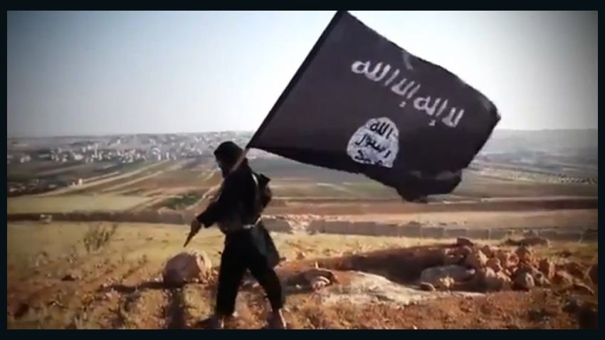 An image grab taken from a video uploaded on YouTube on August 23, 2013 allegedly shows a member of Ussud Al-Anbar (Anbar Lions), a Jihadist group affiliated to the Islamic State of Iraq and the Levant , Al-Qaeda's front group in Iraq, holding up the trademark black and white Islamist flag at an undisclosed location in Iraq's Anbar province. Attacks in Iraq killed 14 people including six soldiers on August 25, Iraqi officials said, amid a surge in violence authorities have so far failed to stem despite wide-ranging operations targeting militants. Arabic writing on the flag reads: "There is not God but God and Mohammed is the prophet of God." AFP PHOTO / YOUTUBE == RESTRICTED TO EDITORIAL USE - MANDATORY CREDIT "AFP PHOTO / YOUTUBE " - NO MARKETING NO ADVERTISING CAMPAIGNS - DISTRIBUTED AS A SERVICE TO CLIENTS FROM FROM ALTERNATIVE SOURCES, THEREFORE AFP IS NOT RESPONSIBLE FOR ANY DIGITAL ALTERATIONS TO THE PICTURE'S EDITORIAL CONTENT, DATE AND LOCATION WHICH CANNOT BE INDEPENDENTLY VERIFIED ====-