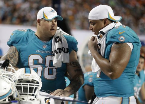 Incognito and Martin talk on the sideline during the second half of a preseason game August 24.