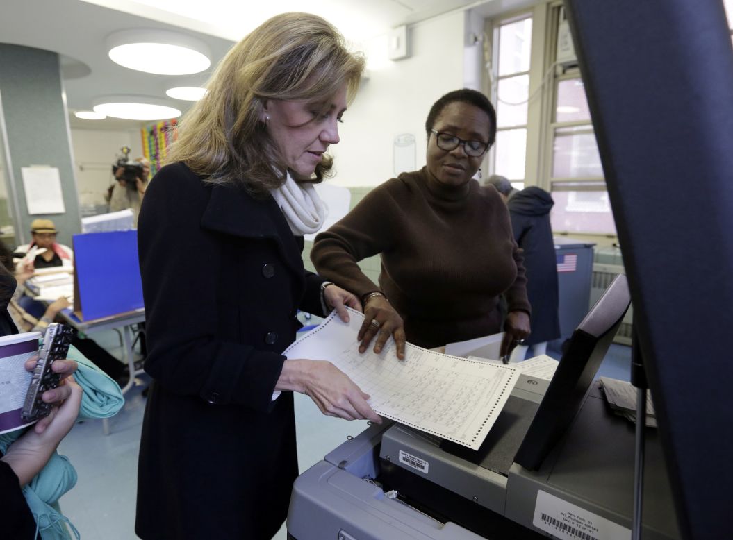 Silda Wall Spitzer, wife of former New York Gov. Eliot Spitzer, has her ballot scanned by Edith Maduakolam at Public School 6. 