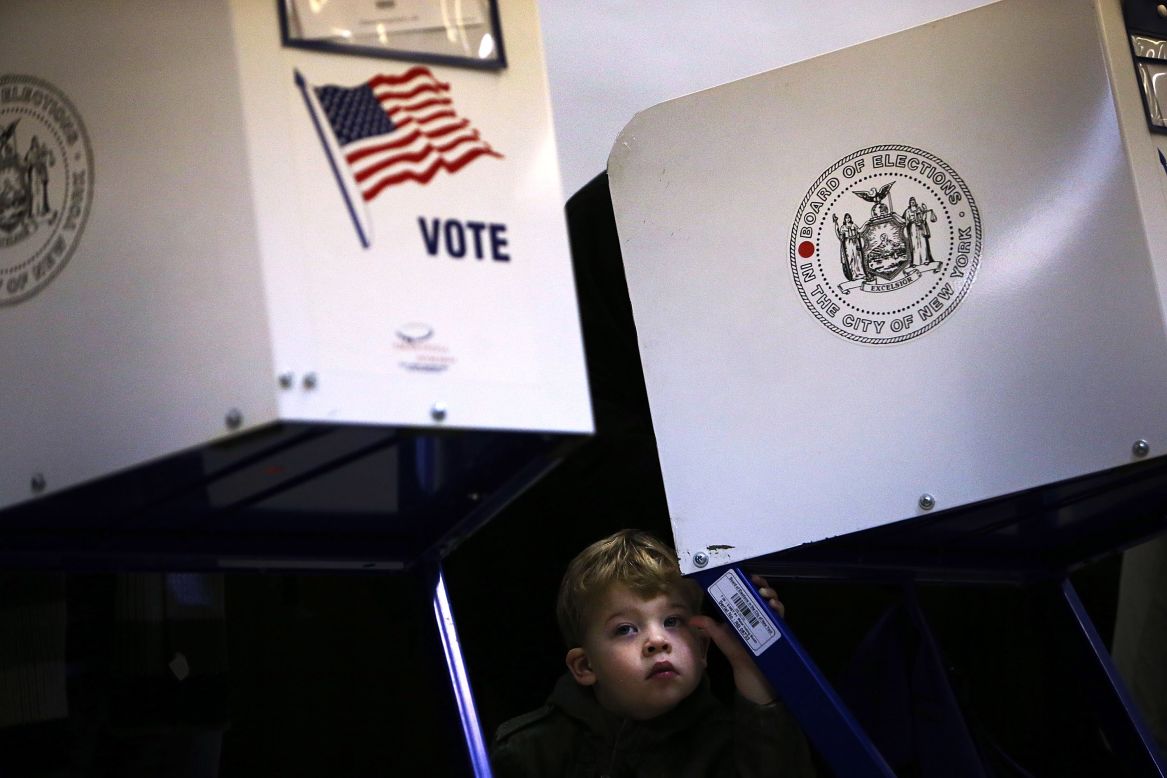 Tobias Nichols, 2, waits for his father, Dan Nichols, to vote in Brooklyn.