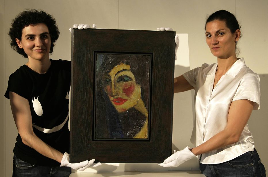 Auction assistants hold German expressionist painter Emil Nolde's portrait "Nadja," in Munich in 2007. The picture, which was considered missing for decades, was found in an attic in Germany. Works by Nolde were among those rediscovered in Munich in 2012.