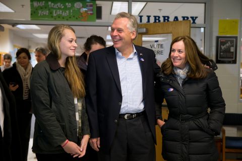 McAuliffe leaves the polls accompanied by his daughter Mary, left, and his wife, Dorothy.