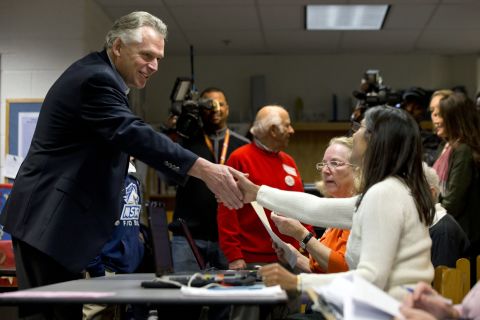 McAuliffe shakes hands with a poll worker as he arrives to vote at Spring Hill Elementary School in McLean, Virginia.