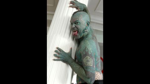 Showman Erik Sprague, also known as "The Lizardman" with his scales and forked tongue, poses for photographs during a 2012 interview in Madrid. 