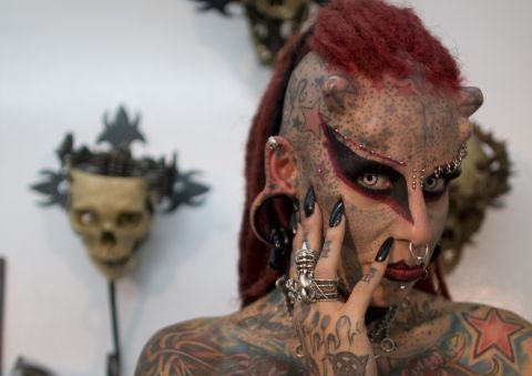Maria Jose Cristerna poses for pictures during a 2011 news conference in Bogota, Colombia. The Mexican tattoo artist said she started to cover her body in tattoos, piercings, titanium implants and dental fangs to reinvent herself as a vampire, her reaction after suffering domestic violence. 