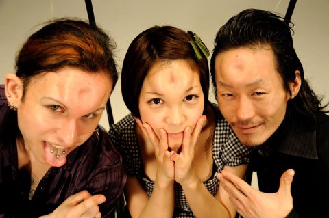 John (left), Marin (center) and Scorpion (right) pose with their "bagel heads" in Tokyo.