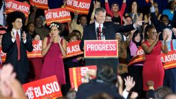 New York City Mayor-elect Bill de Blasio stands alongside his children Dante, left, and Chiara, second left, along with his wife Chirlane, right, as he thanks supporters after winning the mayoral election on Tuesday, November 5.