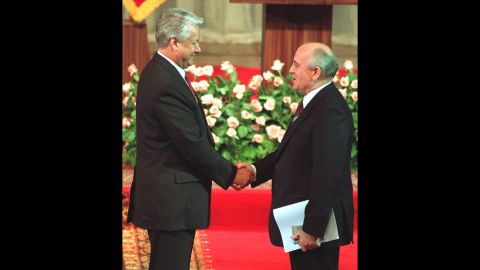 Gorbachev shakes hands with Yeltsin after Yeltsin's investiture as Russian president in Moscow in 1991.