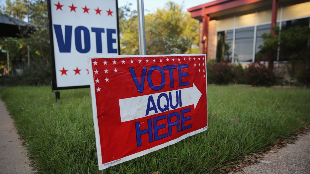 A sign points out a polling center in Austin, Texas. James Moore says the state's voter ID law hurts minorities and women.