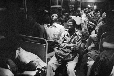 South Africa, 1983: Exhausted workers cram onto a "blacks only" bus traveling from a segregated homeland into Pretoria at two o'clock in the morning. The image is the work of South African photographer David Goldblatt.