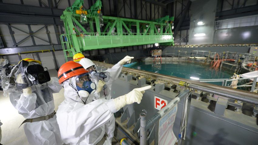 Fukushima Governor Yuhei sato (orange helmet) inspects the spent fuel pool in the unit 4 reactor building of Tokyo Electric Power Co (TEPCO) Fukushima Dai-ichi nuclear power plant at Okuma town in Fukushima prefecture on October 15, 2013. Sato also inspected contamination water tanks as radioactive water leaked early this month. AFP PHOTO / JAPAN POOL via JIJI PRESS JAPAN OUT (Photo credit should read JAPAN POOL/AFP/Getty Images)