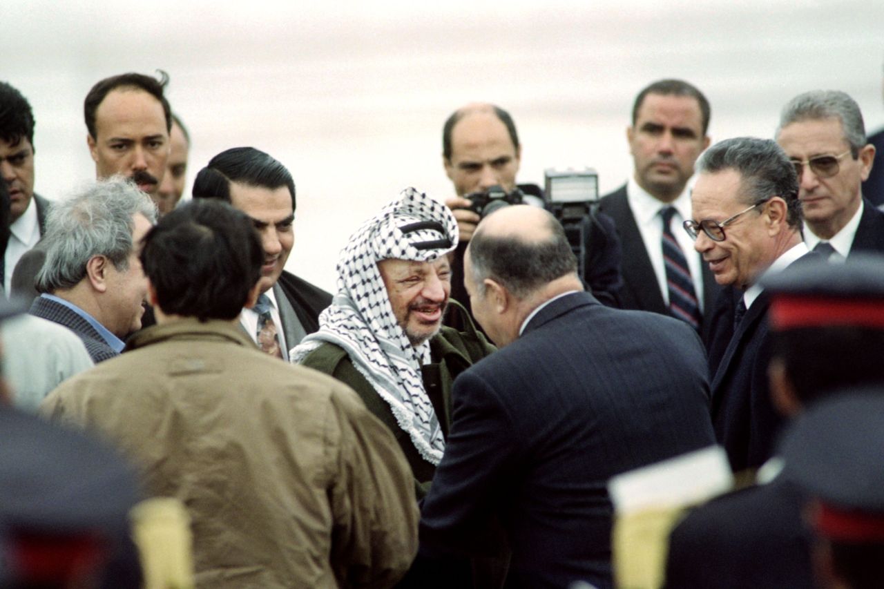 Arafat is greeted by Tunisian Defense Minister Abdelaziz Ben Dhia upon his arrival at the Tunis airport on April 10, 1992. Days earlier, Arafat survived a plane crash over the Libyan desert that killed the pilot and two others.