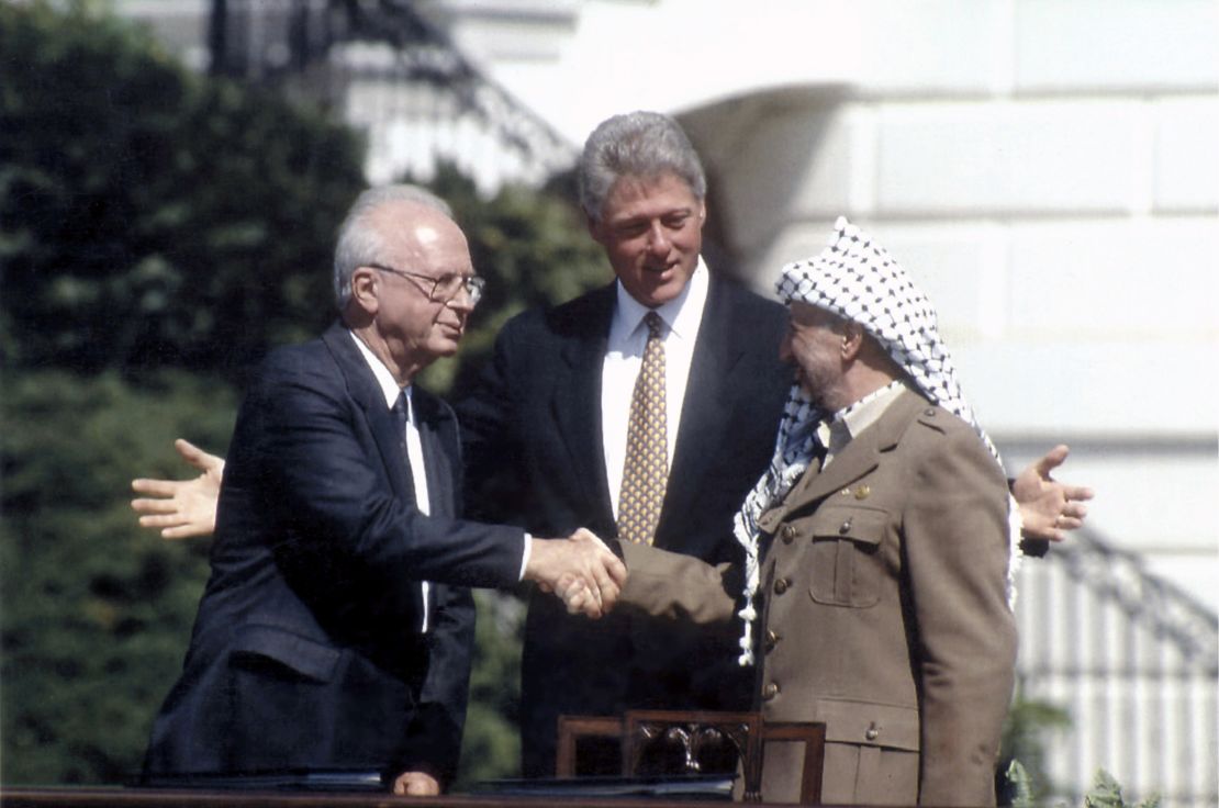 Israeli Prime Minister Yitzhak Rabin and Palestinian leader Yasser Arafat  join U.S. President Bill Clinton at the White House after signing the Oslo Accords in September 1993.