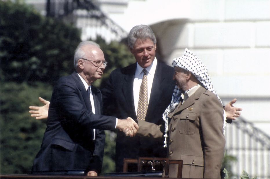 With U.S. President Bill Clinton watching, Arafat shakes hands with Israeli Prime Minister Yitzhak Rabin after the two signed the Oslo peace accord in Washington on September 13, 1993.