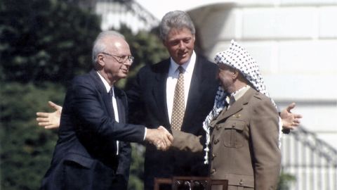 Israeli Prime Minister Yitzhak Rabin and Palestinian leader Yasser Arafat join U.S. President Bill Clinton at the White House after signing the Oslo Accords in September 1993.