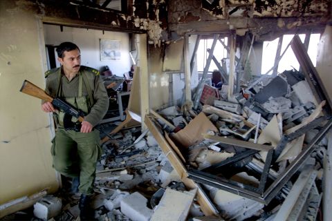 A Palestinian security officer inspects damage to Arafat's seaside office in Gaza City on March 10, 2002. Israeli helicopters attacked the compound hours after an Islamic suicide bombing in Jerusalem.