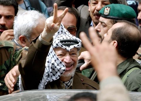 Arafat greets supporters in Ramallah on May 2, 2002, after Israeli soldiers withdrew from his compound late the previous night.