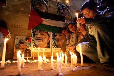 Palestinians hold a candlelight vigil for an ailing Arafat in Ramallah on November 10, 2004. A top aide said Arafat suffered a brain hemorrhage.